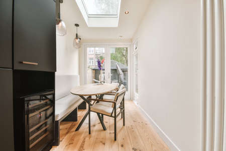 Cozy dining room with a small oval table and gray upholstered furniture