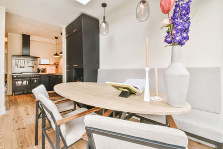 Cozy dining room with a small oval table and gray upholstered furniture