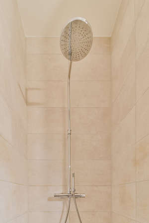 Gorgeous shower room in beige tones with handy faucetの写真素材