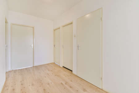 Empty large room of luxury house with wooden flooring and white wallsの写真素材