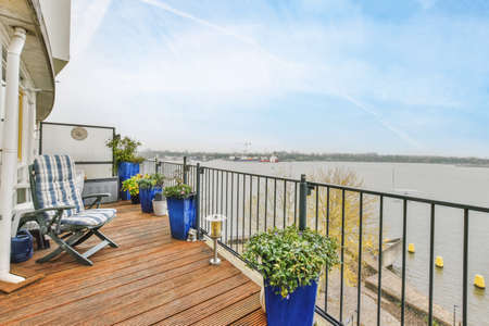 Mind-blowing balcony with wooden floor and metal handrailsの写真素材