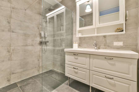 Delightful minimalist bathroom interior with illuminated mirror
