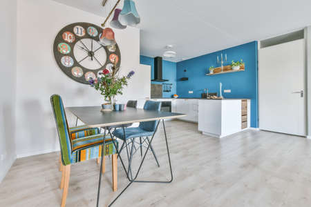 Interior of the light kitchen with modern appliances in a modern flat at daytime