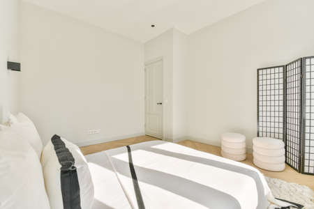 Interior of a cozy and bright bedroom with beautiful decorationの写真素材