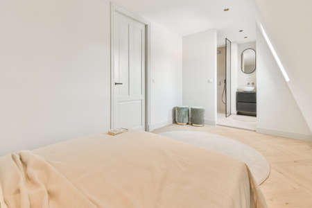 Interior of a cozy and bright bedroom with beautiful decorationの写真素材