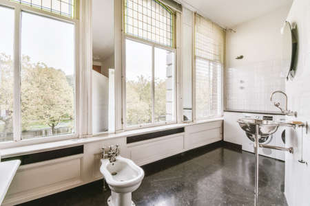Amazing bathroom with black floor and large windowsの写真素材