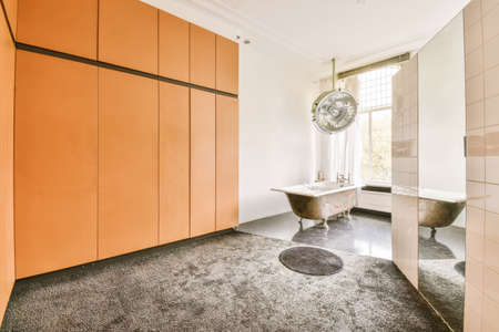 Comfortable large bathroom with a clawfoot bathtub and gray floorの写真素材