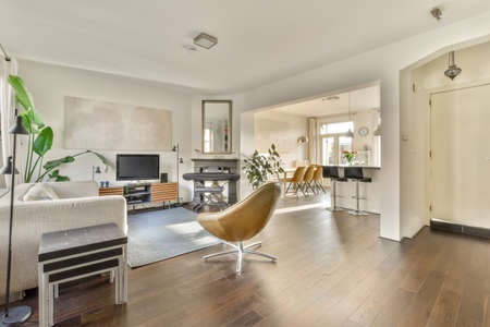 Comfortable sofa with cushions placed against light wall with decorations in modern living roomの写真素材