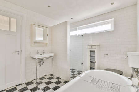 Adorable bathroom with black and white checkerboard floorの写真素材