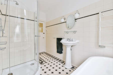 Sleek bathroom with black and white checkerboard tiled floor