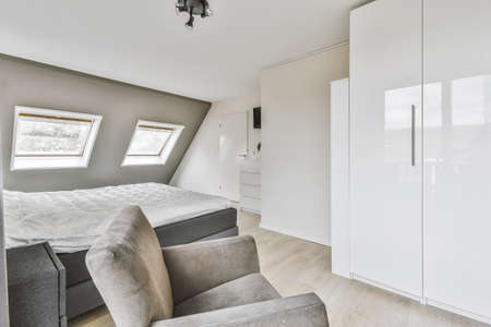 Wonderful bedroom with gray bed and parquet wood floor