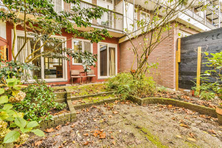 Nice courtyard of a house with trees and a garden