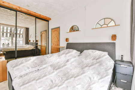 Delightful bedroom with soft bed in daylight