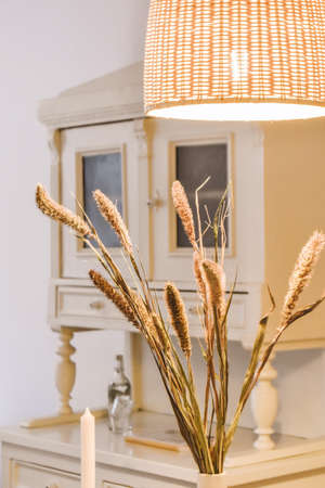 Adorable home decor in the form of a vase with a flower on the tableの写真素材