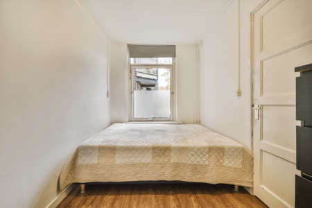 Stunning bedroom with a large bed next to a small window