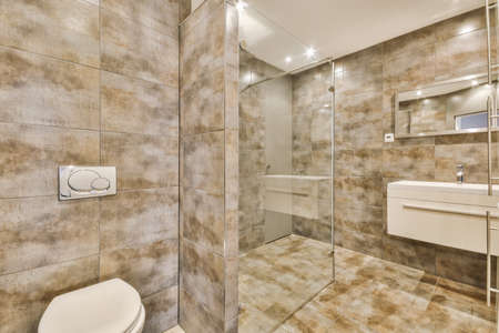 Amazing bathroom with brown tiles and white sink