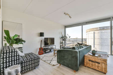 Stylish and cozy living room with soft decorative huge sofaの写真素材