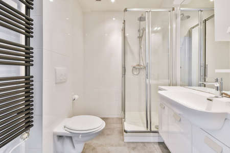 Stunning stylish bathroom with large sink and mirror opposite the radiator