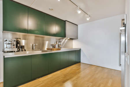 Cozy and stylish kitchen with emerald kitchen set and coffee machine