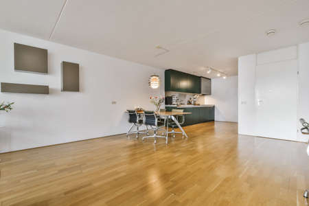 Cozy huge room with a small dining area with stylish table and chairs
