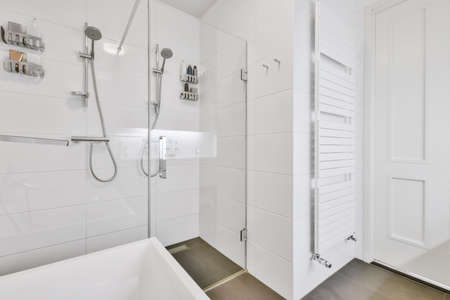Lovely snow-white bathroom with shower and radiator