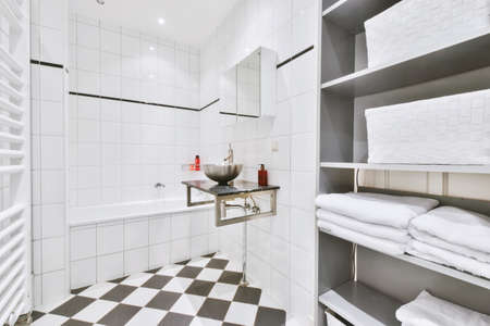 Charming bathroom with a large bathtub and a black marble countertopの写真素材