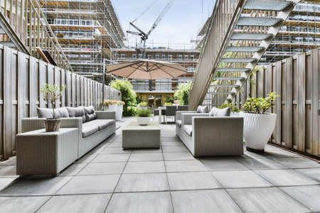 Stylish courtyard with table and chairs and pots of flowers