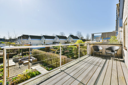 Stunning balcony with wooden floor and two wicker chairs