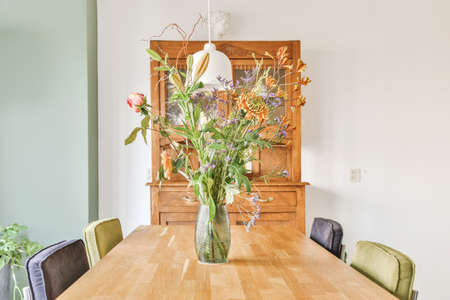 A delightful dining room with a wooden cupboard for dishes and a table