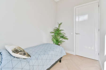 Stylish bedroom with a soft bed with decorative pillowsの写真素材