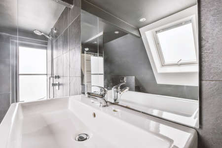 White sink with square mirror in luxury bathroom in gray tones