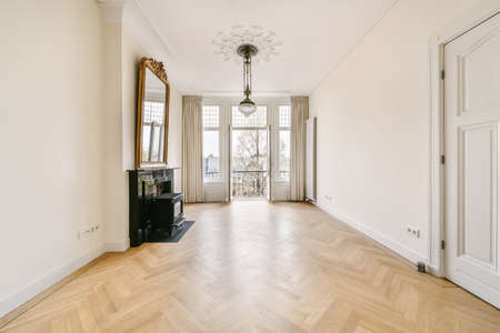 An amazing room with a black fireplace and a large mirror in a luxurious houseの写真素材