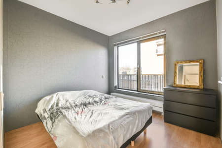 Light modern master bedroom interior with soft bed