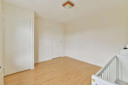 An empty room with white walls and wooden floor