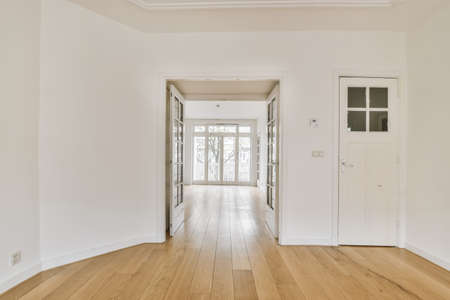 Lovely empty room with door and parquet floor
