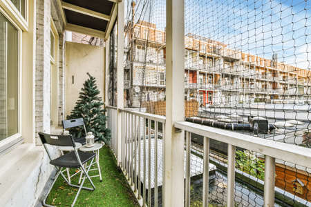 Fascinating design of the balcony with chairs and a Christmas tree