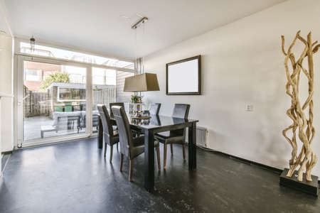 Adorable dining room with black table and leather black upholstered chairs