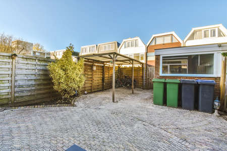 Amazing home courtyard with trash cans and bicyclesの写真素材