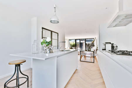 Stylish kitchen in a minimalist style with a snow-white kitchen set