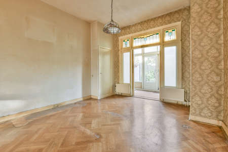 entrance door to the empty room with half wallpapered wallsの写真素材