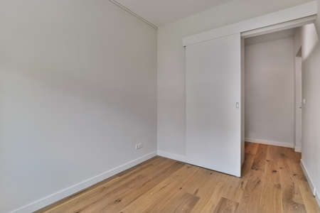 A wonderful empty room with a wooden floor and white wallsの写真素材