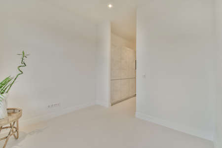 interior of an empty room with white floor and walls
