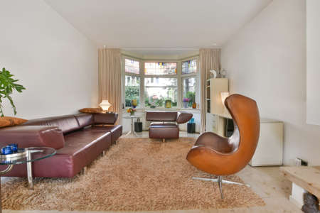 living room interior with leather sofa and armchair Real photo
