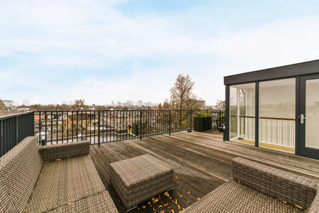 The exterior of the roof with an amazing wooden floor and black railings