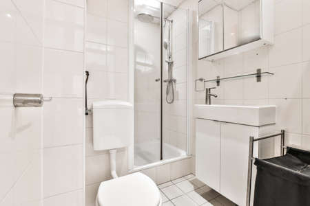 White ceramic toilet bowl with water tank