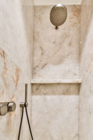 An attractive bathroom with a shower cabin and marble walls and a convenient faucetの写真素材