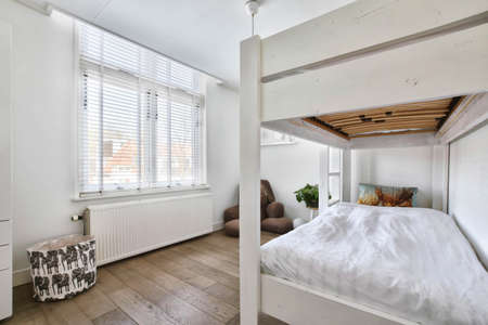 Elite small room with a two-storey bed and a large teddy bear