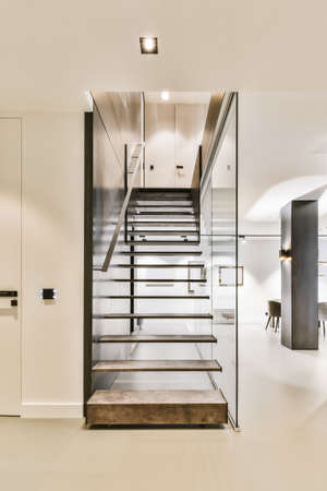 Attractive staircase in dark colors with comfortable handrails