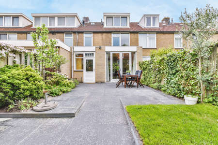 A delightful courtyard of the house with greenery and a beautifully laid stoveの写真素材