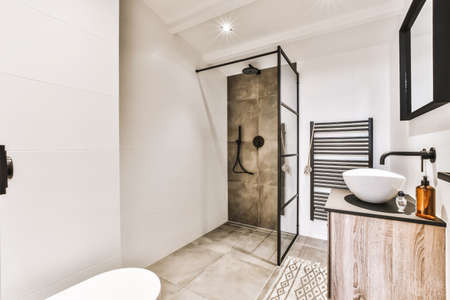 Stylish bathroom with oval sink and mirror in black frame